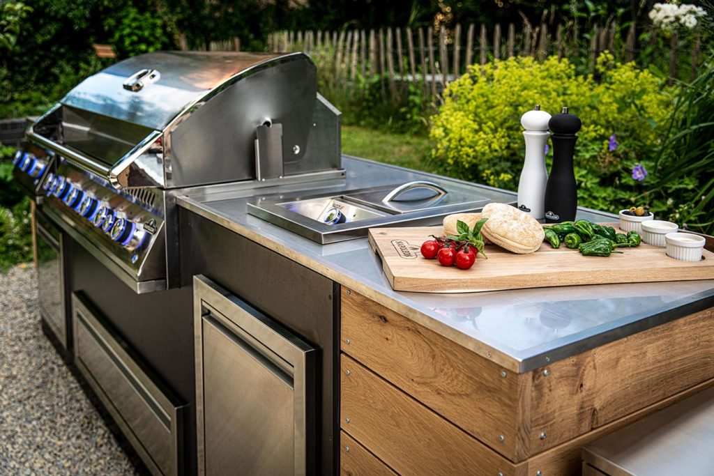 Built-in grill insert in a stone outdoor kitchen island