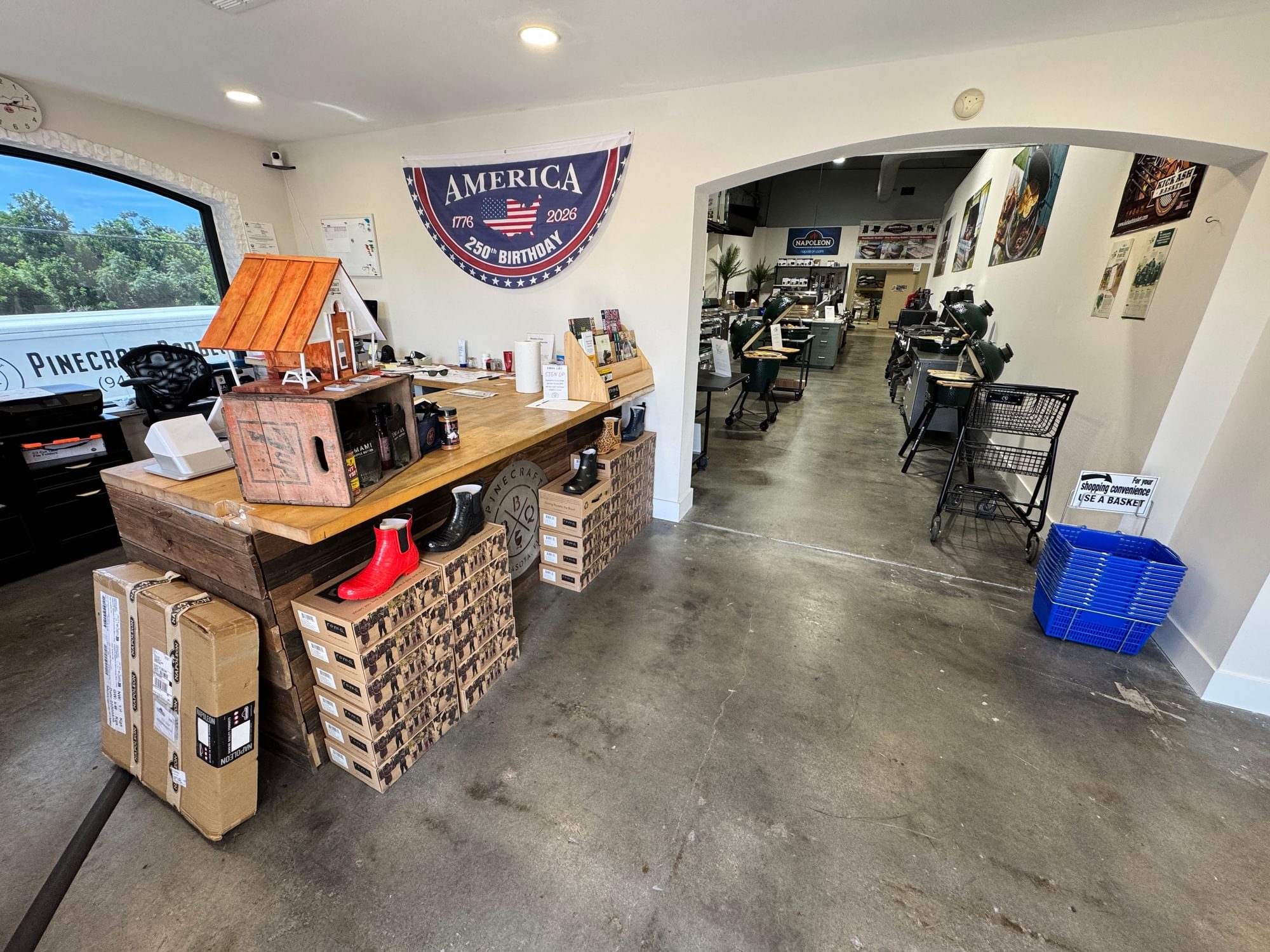 Wood service counter with rubs, sauces, baskets, and a showroom beyond.