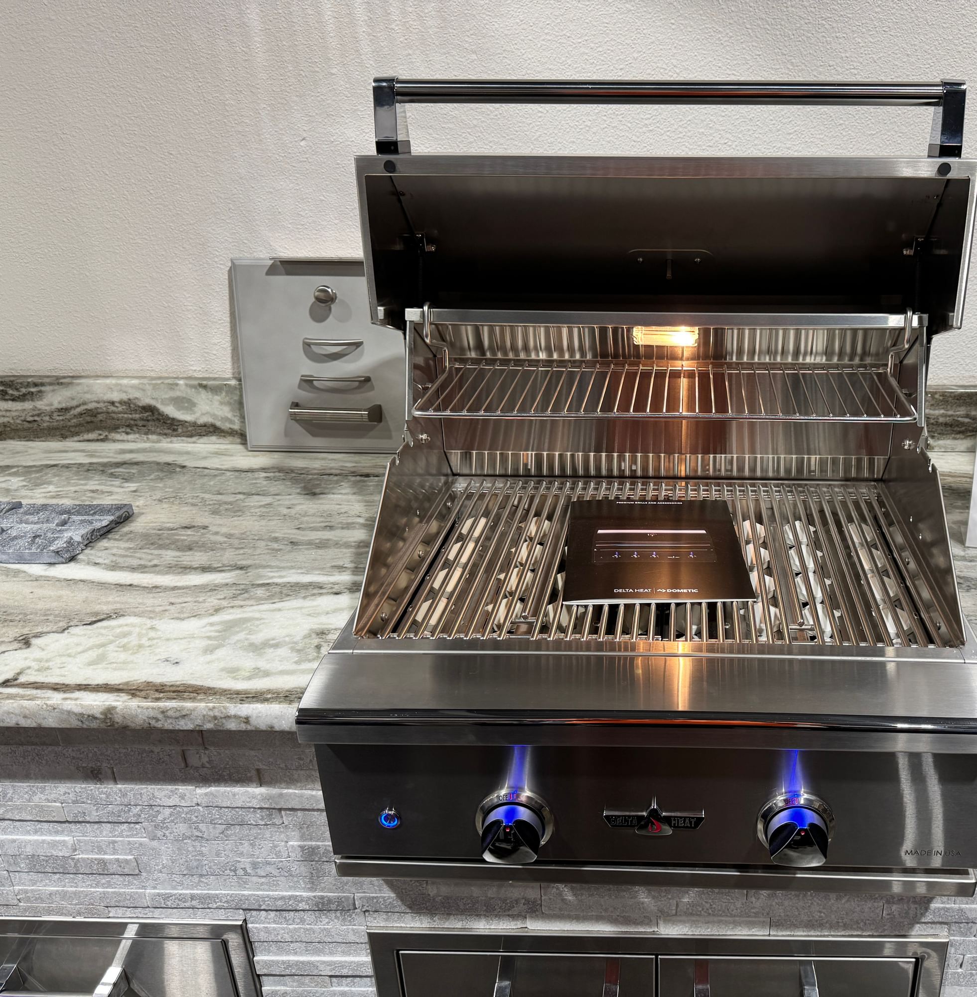 Open Delta Heat built-in grill on a stone counter.