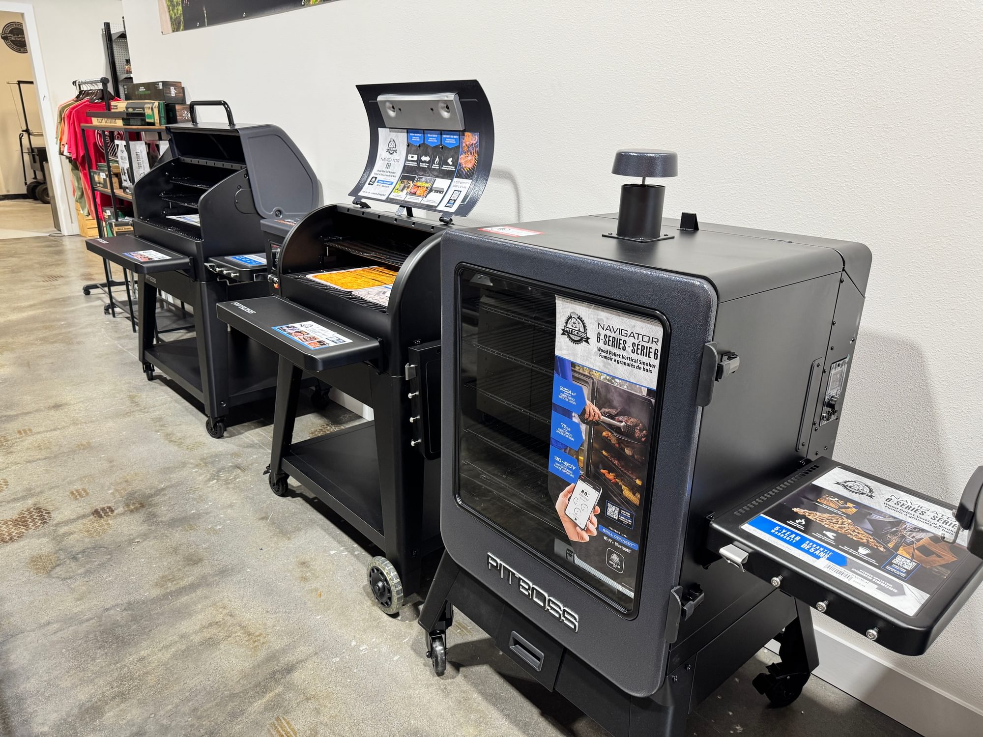 Pit Boss pellet grills and a vertical smoker along an interior wall.
