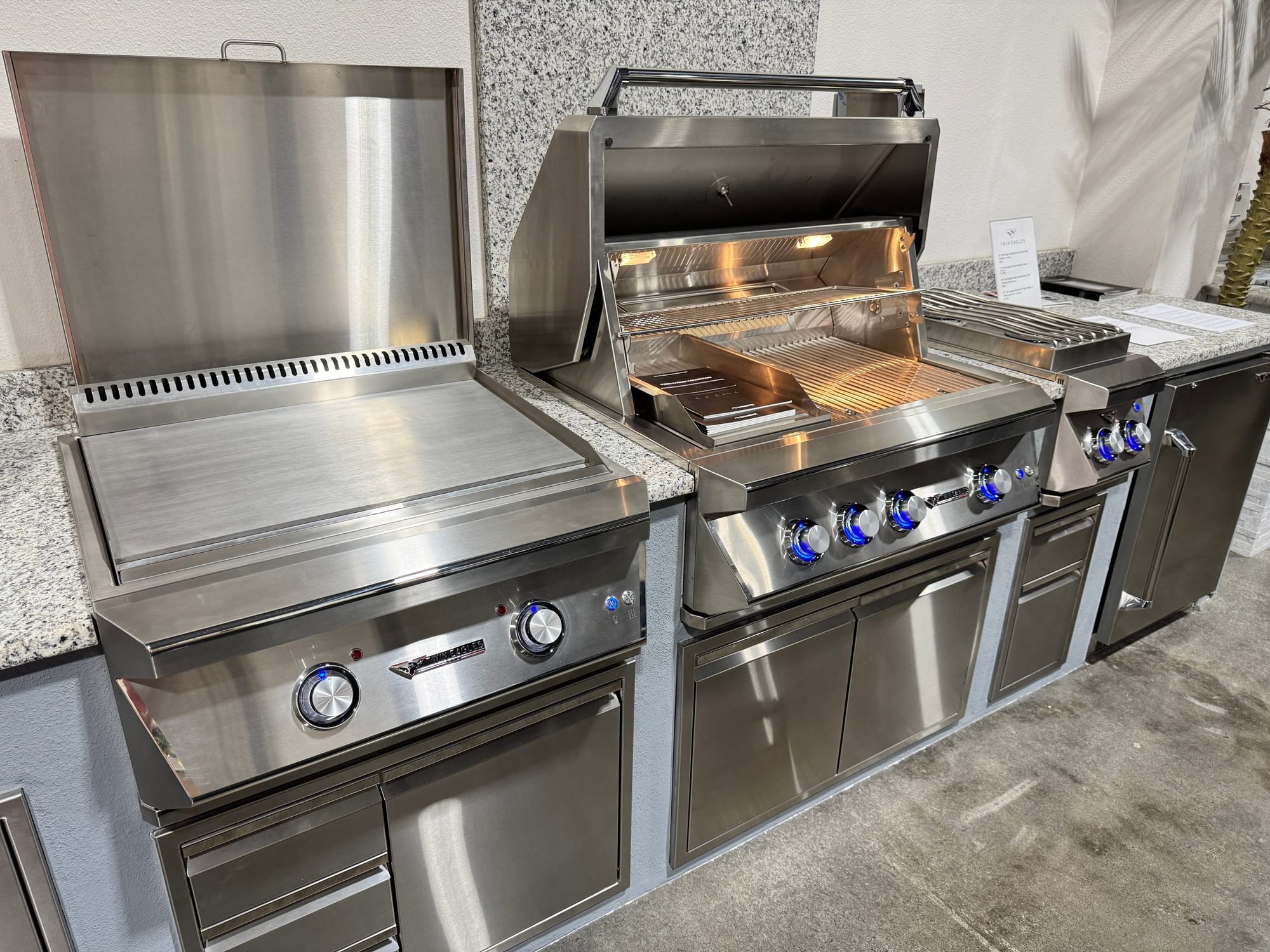 Twin Eagles griddle, grill, and side burner in an outdoor kitchen island.