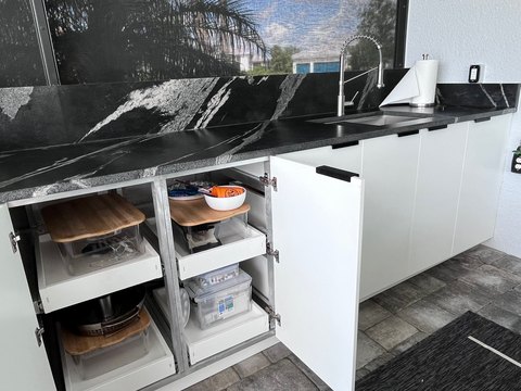Open cabinet with pull-out shelves.